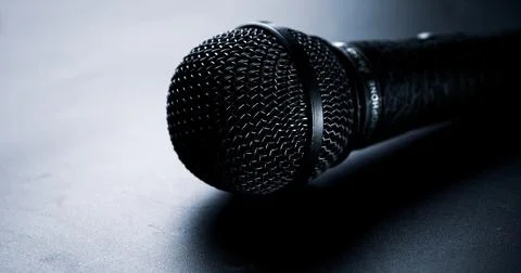 Close up of black microphone on a black background. Stock Photos