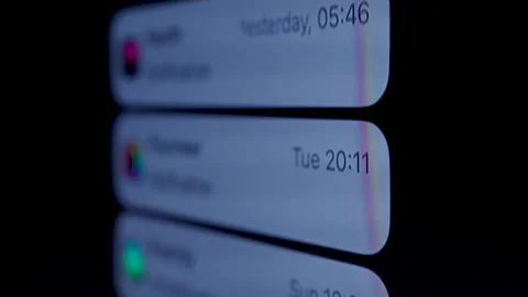Close-up, Black mobile phone screen shows various notifications. Stock Footage 310431286