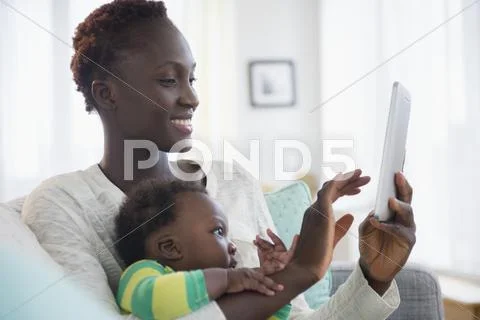 Close Up Of Black Mother And Baby Boy Using Digital Tablet