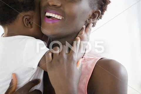 Close Up Of Black Mother Holding Son