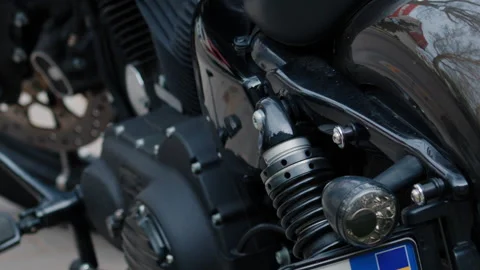 Close up of a black motorcycle engine, rear suspension, and glossy body details Stock Footage 335465093