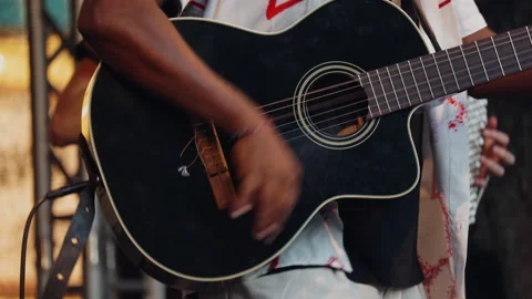 Close up of a Black musician's hand playing an acoustic-electric guitar dur.. Stock Footage 339622991
