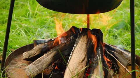 Close up of black pan on campfire. Camp on travel, place for bonfire Stock Footage 323762763