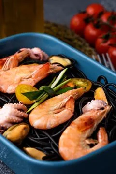 Close-up of black paste with cuttlefish ink with seafood-shrimps, mussels, oc Stock Photos