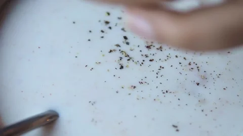 Close up of black pepper being ground onto creamy white food or sauce. 스톡 동영상 331719609