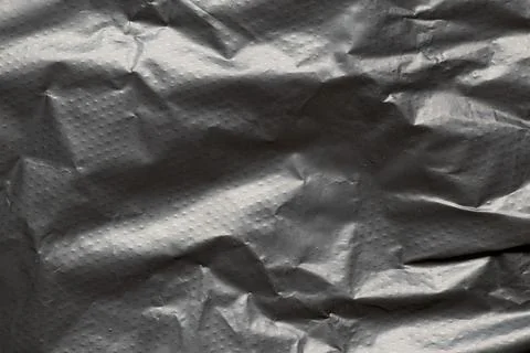 A close-up of a black perforated plastic bag. The texture of the packaging .. Stock Photos