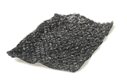 Close up of black plastic bubbles on a bubble wrap isolated by white backgr.. Stock Photos