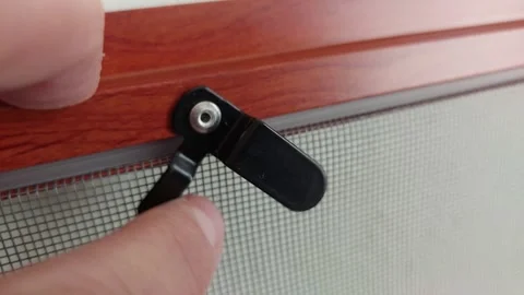 Close-up of black plastic clip for window insect screen Vídeos de archivo 334733553