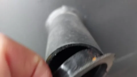 Close-up of a black plastic pipe with internal screw thread, removing rubber pro Stock Footage 335474895