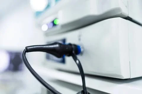 Close-up of a black plug connected to a white device Stock Photos