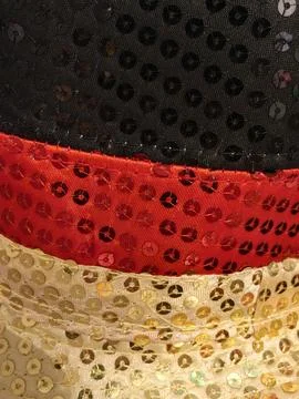 Close-up of black red and gold sequined fabric texture Stock Photos