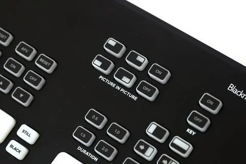 Close-up of black remote control with buttons and labels Фото
