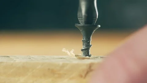 Close-up black self tapping screw unscrewing from board by man. Macro view Stock Footage 313880509