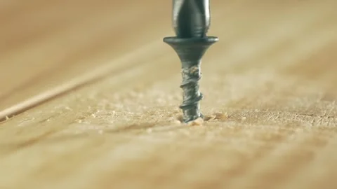 Close-up black self tapping screw unscrewing from wood by man. Macro view Stock Footage 317332646