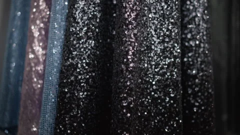 Close up black sequin dress fabric with sparkling textured material hanging Stock Footage 346735171