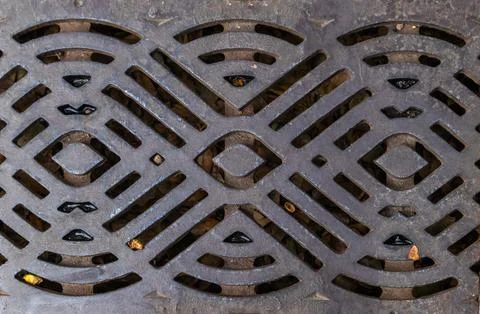 Close up of black sewer grate with pattern, copy space, background texture Stock Photos