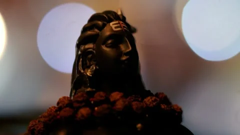 Close-up of a black Shiva statue with glowing light in the background showc.. Stock Footage 316968702