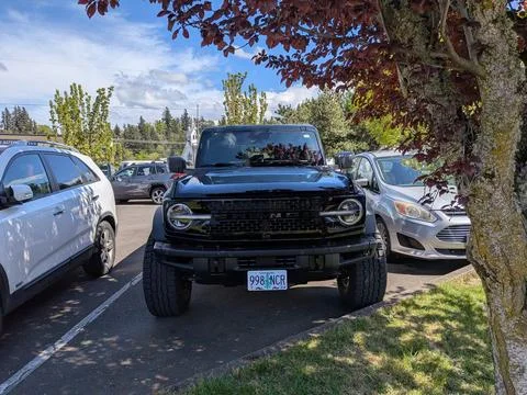 Close-up of a black sixth-generation Ford Bronco parked among Oregon vehicles Photos