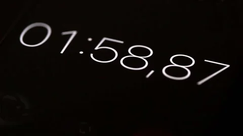 Close-up black smartphone digital stopwatch with white numbers running Stock Footage 223341198