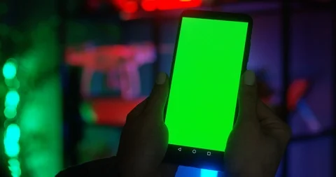 Close up of the black smartphone with green screen in hands of the Caucasian Stock Footage 104983500