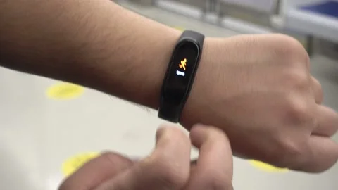 Close up black smartwatch displaying jogging activity on wrist Stock Footage 144487594