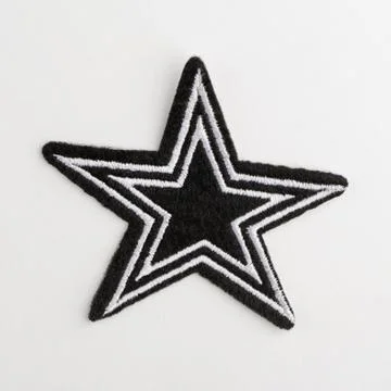 Close up on a black star fabric patch on white background Stock Photos