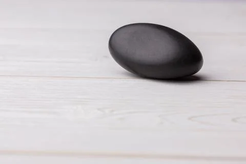 Close-up of black stone on table Illustrazione stock