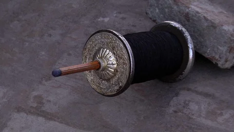 Close Up Of Black String Being Spun Out From Kite Spindle Held Down By Stock Footage 117056057