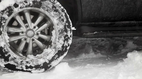 Close up of black SUV rear wheels spinning in the snow. Stock Footage 33842378