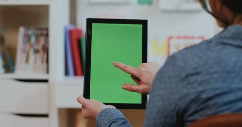 Close up of the black tablet device with green screen in hands of the Caucasian Stock Footage 104213481