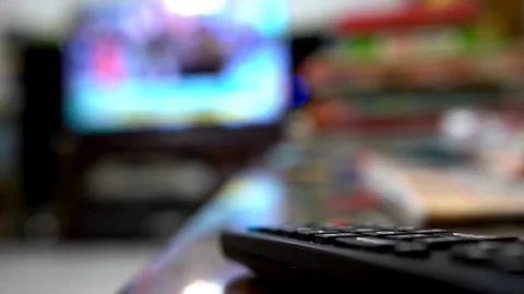 Close up of a black television remote control on a coffee table. Stock Footage 257873939