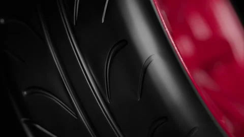 Close-up of a black tire tread with a red accent, abstract automotive detail Stock Footage 325791282