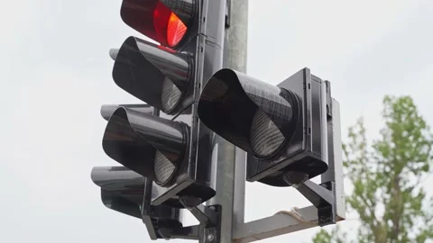A close-up of a black traffic light counts down the time for pedestrians with a Stock Footage 218949402