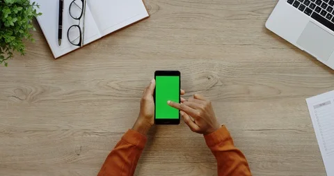 Close up of the black vertical smartphone being on the light wooden desk of the Stock-Footage 96005903