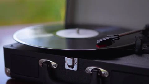 Close up of black vinyl record spinning on vintage turntable record player Stock Footage 341341451