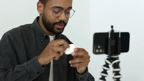 Close up black vlogger using phone camera on tripod. Social media influencer 4k Stock Footage 179954037