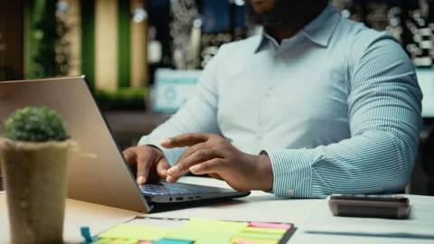 Close up of black worker proofreading and fact checking financial data Stock Footage 320086992