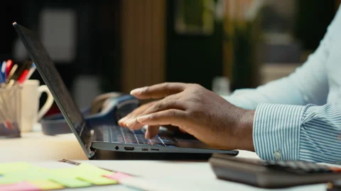 Close up of black worker proofreading and fact checking financial data Video stock 320723018