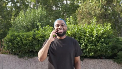 Close-up of black young man talking to a friend with mobile phone 2 스톡 동영상 285659068