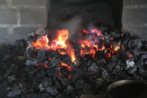 Close up of a blacksmith forge with a coal fire Stock Photos
