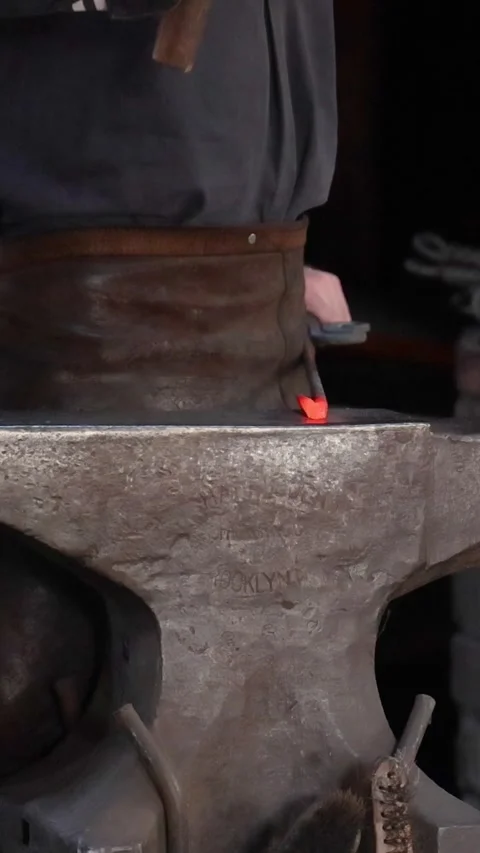 Close Up of Blacksmith Hammering Glowing Hot Metal on Anvil Video stock 329606254