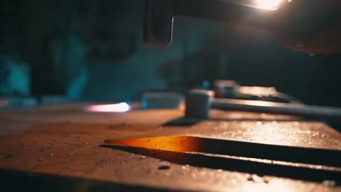 A close-up of a blacksmith hitting hot metal in a workshop. Stock Footage 224945182