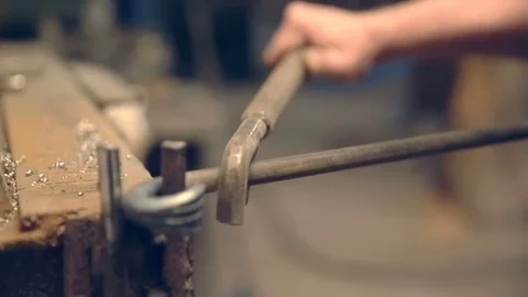 Close-up blacksmith shapes the metal manually Stock Footage 77006206