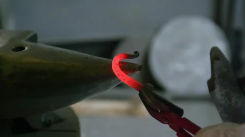 Close-Up of Blacksmith Shaping Hook from Hot Metal on Anvil Stock Footage 313847834