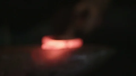 Close up of blacksmith shaping hot metal with hammer Видео 89327634