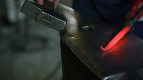 Close-Up of Blacksmith Shaping Hot Metal Tip on Anvil – Hammering Scene Stock Footage 313847809