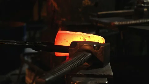 Close-up, a blacksmith strikes a red-hot metal with a hammer. Stock Footage 143462288