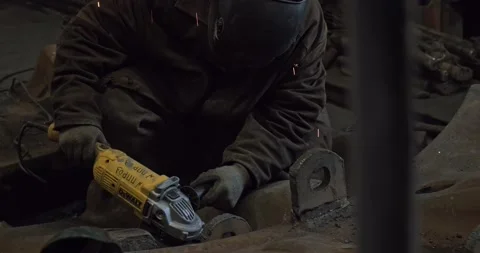 Close-up blacksmith welder in protective mask works with metal steel and iron Stock Footage 132403009