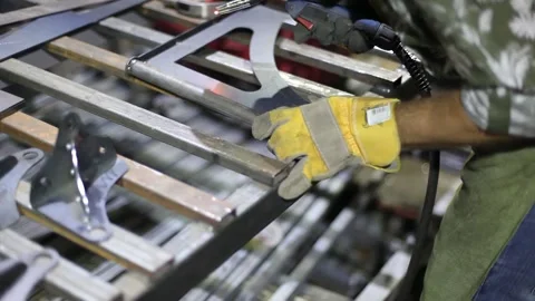 Close-up blacksmith welder in protective mask works with metal using a welding Stock Footage 139586376