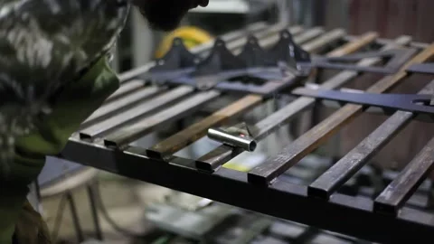 Close-up blacksmith welder in protective mask works with metal using a welding Stock Footage 139586590
